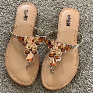 Gold and orange flip flops